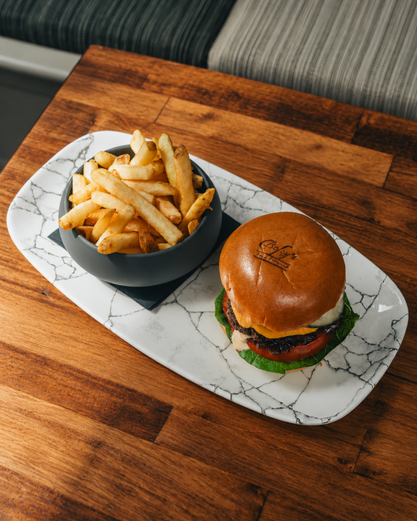 Bofey Quinn’s burger and chips on a marble serving platter