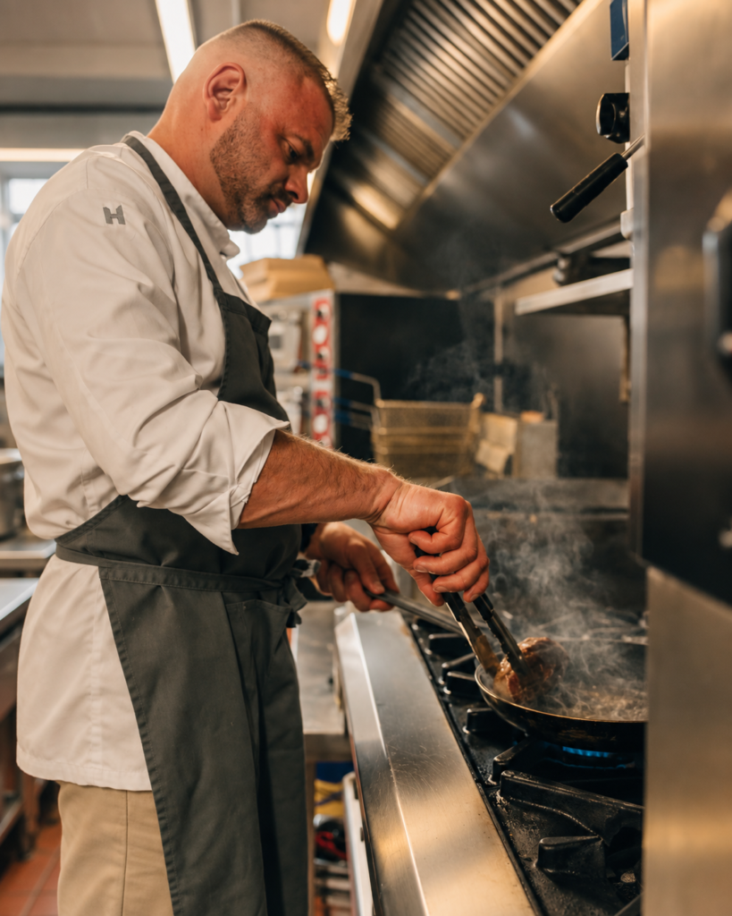 Chef cooking at the stove in Bofey Quinn’s kitchen