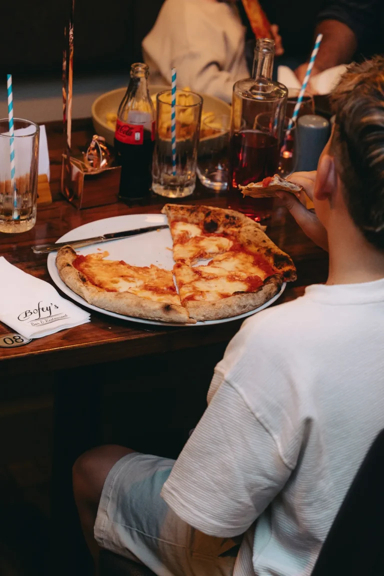 Enjoying a slice of pizza
